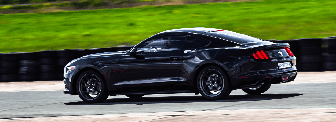 Czarny Ford Mustang na torze wyścigowym - mustang legenda motoryzacji